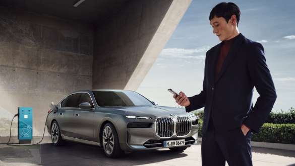 Charging card BMW i7 Sedan G70 Charging Card in the foreground BMW i7 Sedan G70 BMW Individual Oxid grey metallic charging in background