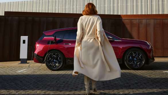 BMW iX M60 i20 2022 electric SUV electric car Connected Charging woman in front of BMW iX