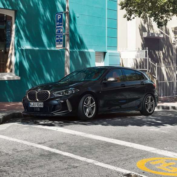 BMW M135i xDrive, three-quarter side view F40. The all-new BMW M135i xDrive in Black Sapphire metallic, three-quarter side view parking F40.