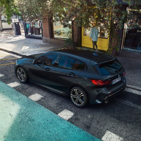 BMW M135i xDrive, parking F40. BMW M135i xDrive in Black Sapphire metallic parking, bird’s eye view of the side F40.