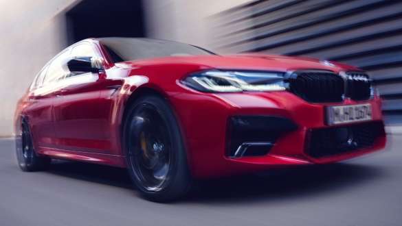 BMW M5 Competition with M xDrive F90 2020 three-quarter front view BMW M5 Competition with M xDrive F90 LCI Facelift 2020 BMW Individual Imola Red three-quarter front view driving