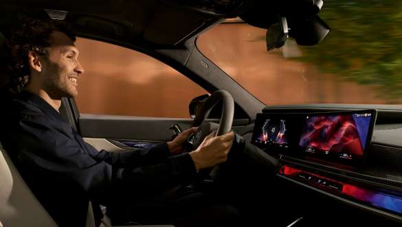 BMW interior man looks at BMW Curved Display BMW interior man in cockpit looks at BMW Curved Display