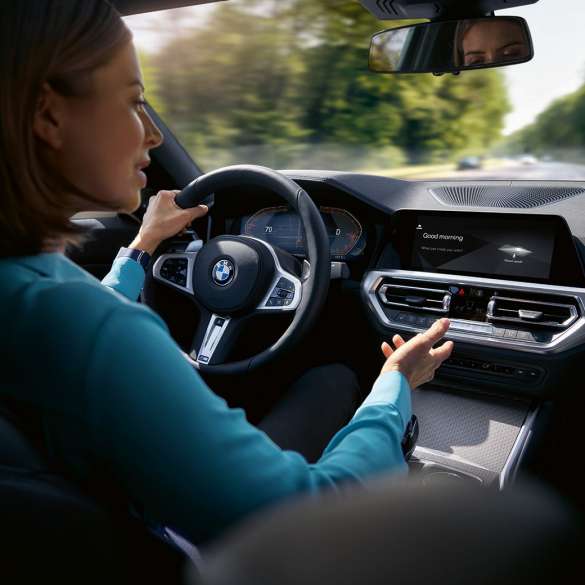 Woman using Intelligent Personal Assistant in her BMW Woman using BMW ConnectedDrive Intelligent Personal Assistant in her BMW
