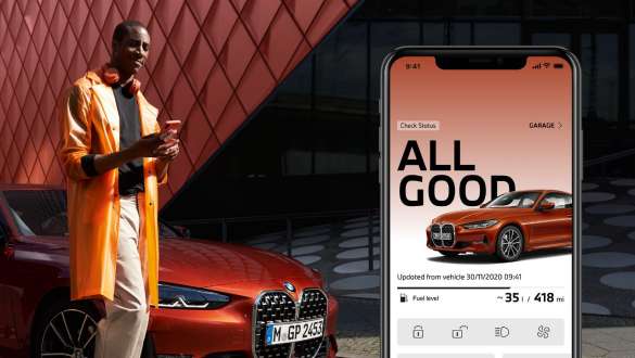 Man uses My BMW App from BMW ConnectedDrive on smartphone in front of a BMW 4 Series Coupé Man uses My BMW App from BMW ConnectedDrive on smartphone in front of a BMW 4 Series Coupé