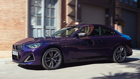 BMW 2 Series Coupé M Automobile G42 MP three-quarter side view driving on the street BMW 2 Series BMW 2 Series Coupé M Automobile G42 MP three-quarter side view driving on the street