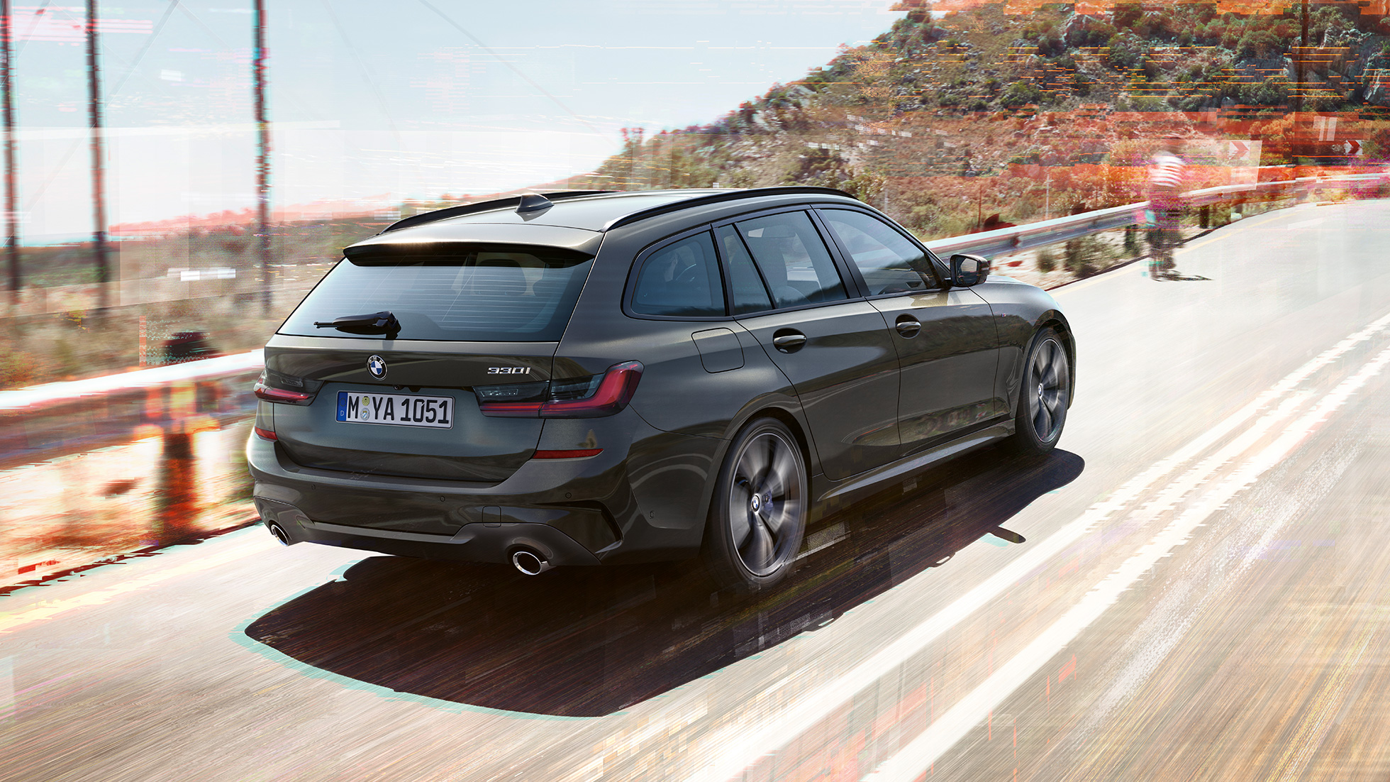 BMW 3 Series Touring G21, three-quarter rear shot BMW 3 Series Touring G21, three-quarter rear shot driving on bridge in front of rural surroundings