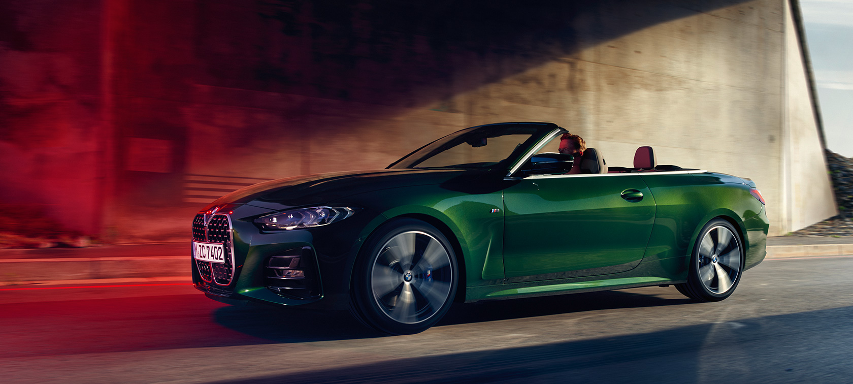 Three-quarter side view BMW 4 Series Convertible G23 2020 in motion BMW 4 Series Convertible G23 2020 Sanremo Green metallic three-quarter side view in motion