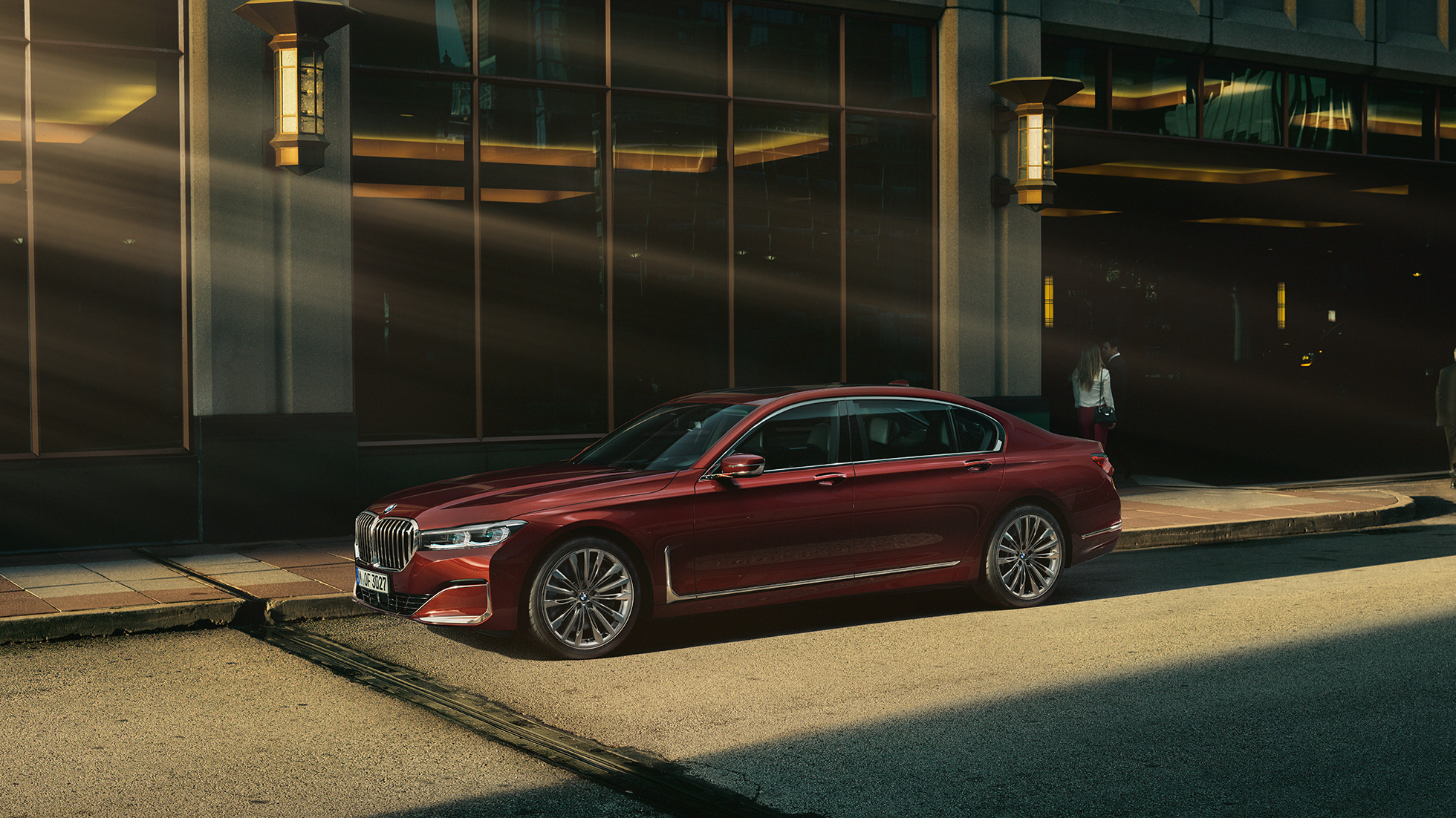 BMW Individual 7 Series Sedan G11, side view BMW Individual 7 Series Sedan G11 in red in side view in front of urban setting