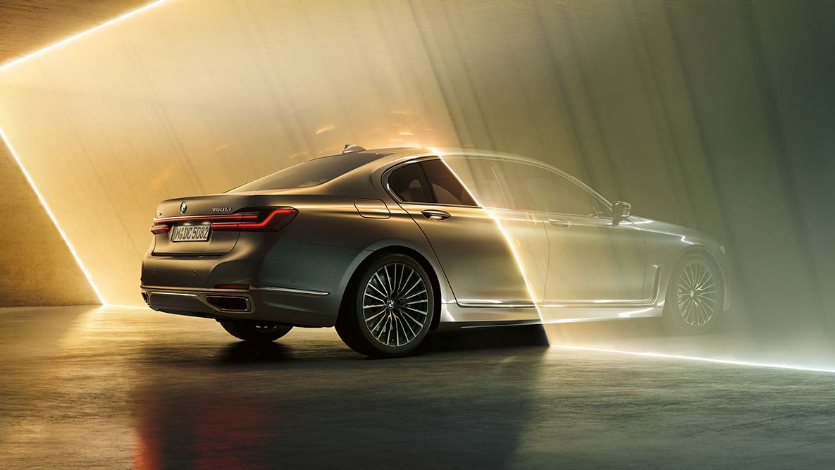 BMW 7 Series Sedan G11 in Bernina Grey BMW 7 Series Sedan G11 in Bernina Grey in three-quarter rear view surrounded by beam of light
