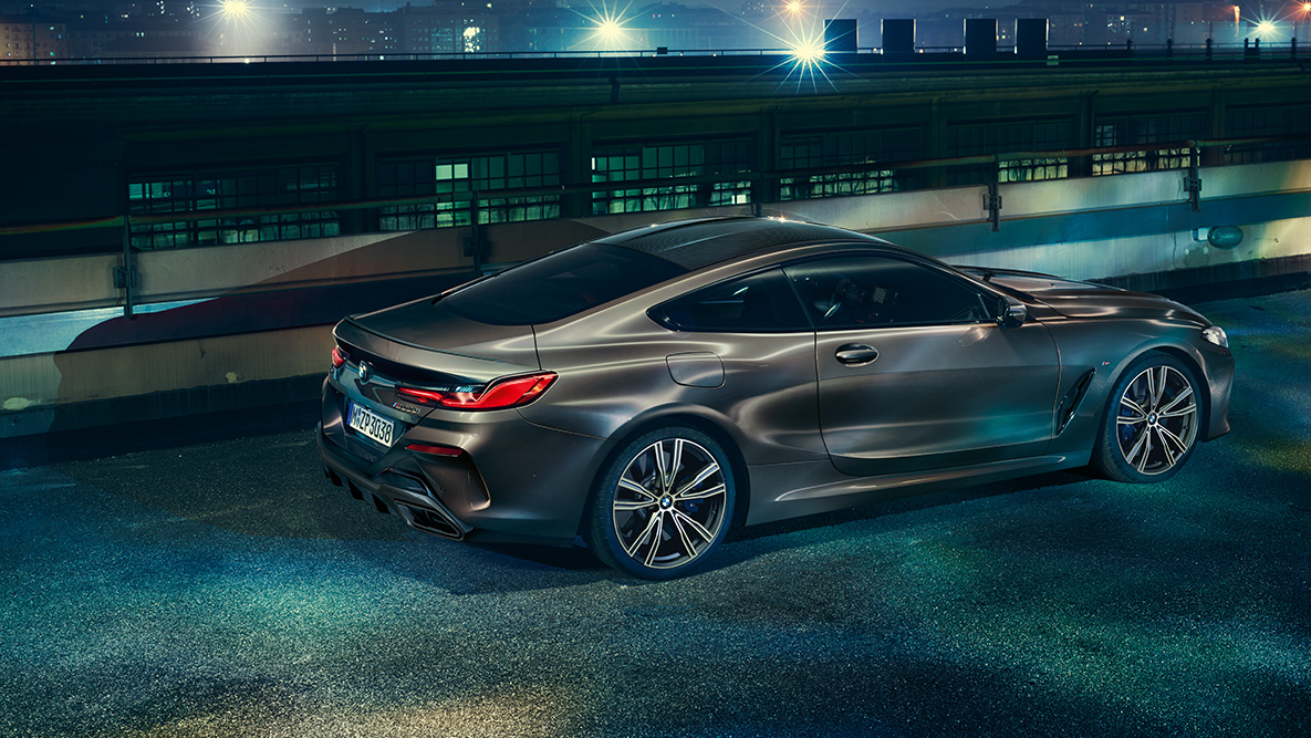 Still shot of the BMW 8 Series Coupé with BMW Individual equipment from the side in an urban setting at night G15. Still shot of the BMW 8 Series Coupé with BMW Individual equipment from the side in an urban setting at night G15.