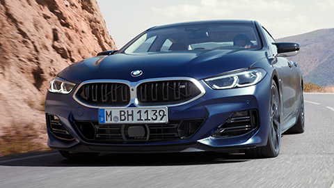 BMW 8 Series Gran Coupé (G16) three-quarter rear view driving BMW 8 Series Gran Coupé (G16) three-quarter rear view driving