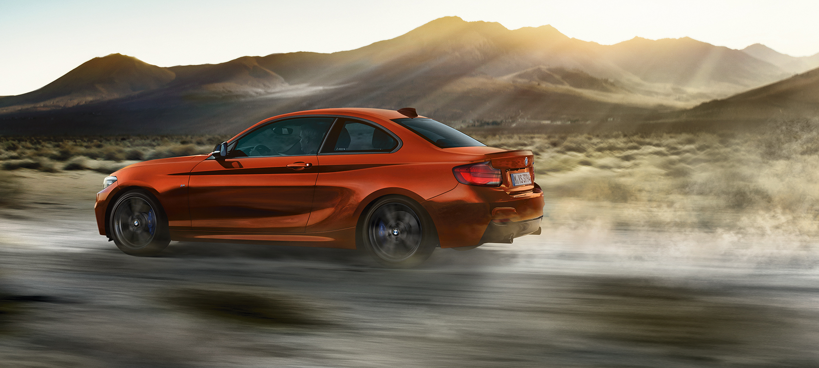 Driving dynamics BMW M240i Coupé F22 Driving dynamics BMW M240i Coupé F22 2017 Sunset Orange metallic side view
