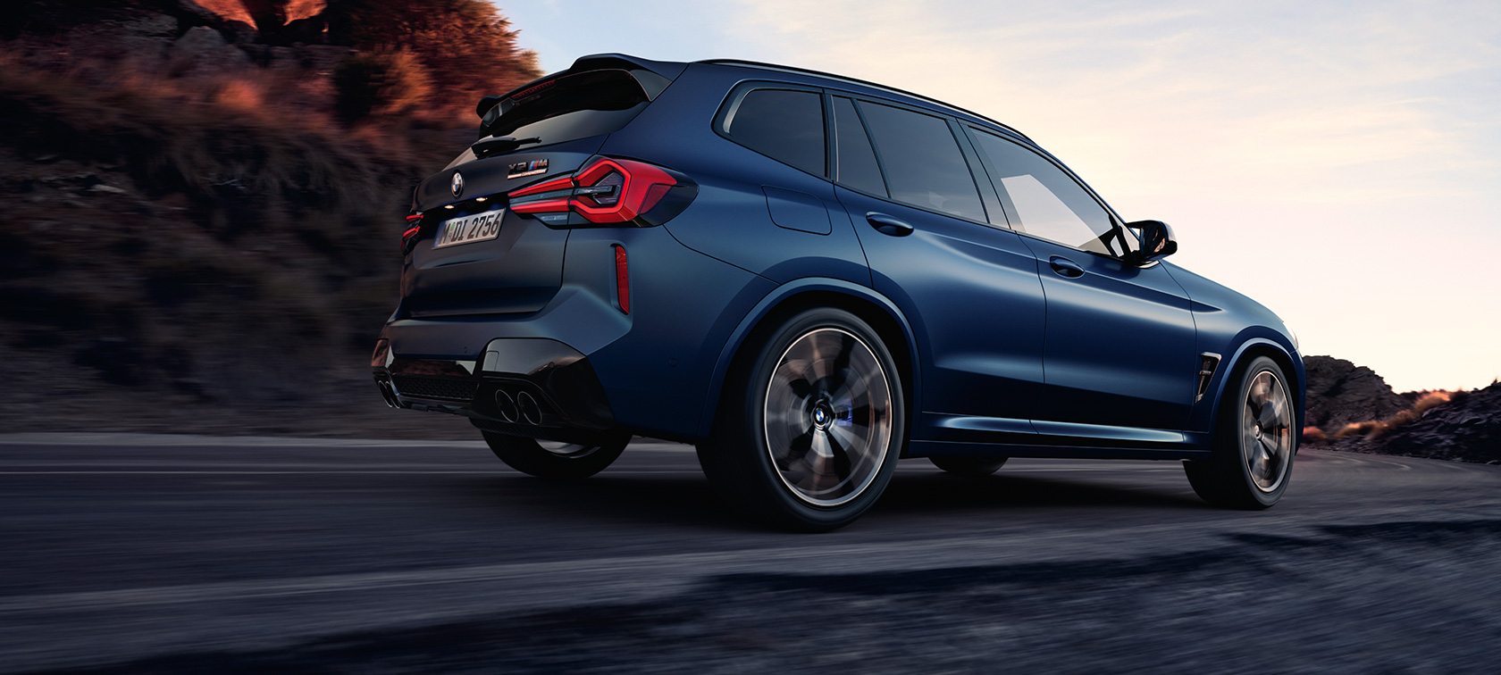 BMW X3 M Competition F97 LCI 2021 three-quarter rear view low angle shot BMW X3 M Competition F97 LCI Facelift 2021 Frozen Marina Bay Blue metallic driving three-quarter rear view low angle shot