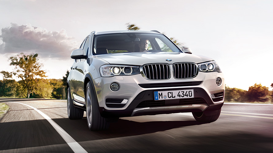 BMW X3 F25 second generation three-quarter rear view driving on the street BMW X Series BMW X3 F25 second generation three-quarter rear view driving on the street