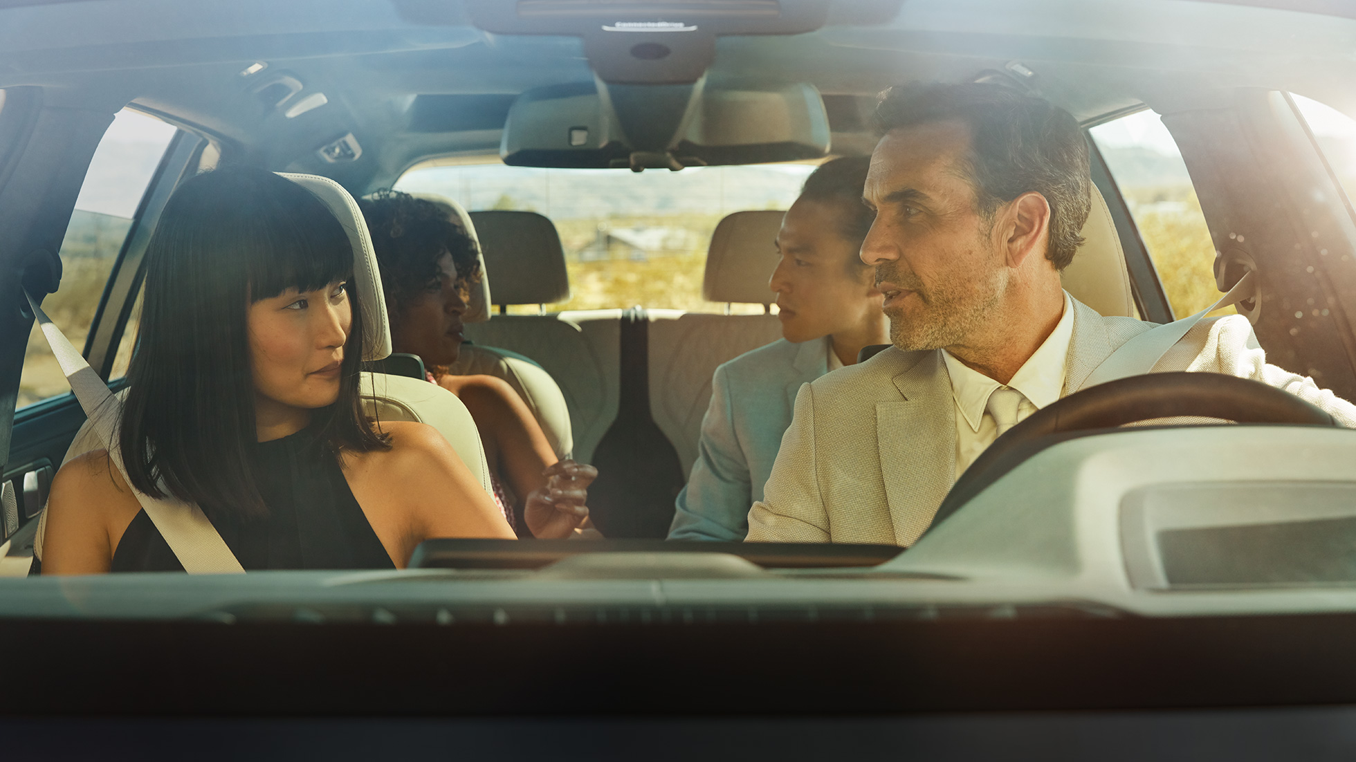 BMW Gesture Control SUV G07 Man and woman are sitting in the car, woman is applying the gesture control SUV G07