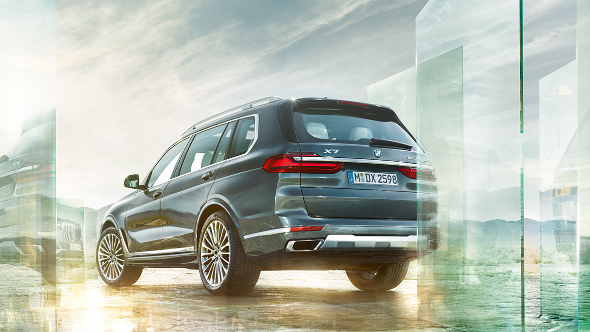 BMW X7 SUV Comfort and Driving Dynamics G07 BMW X7 SUV in the three-quarter rear view in front of abstract background G07