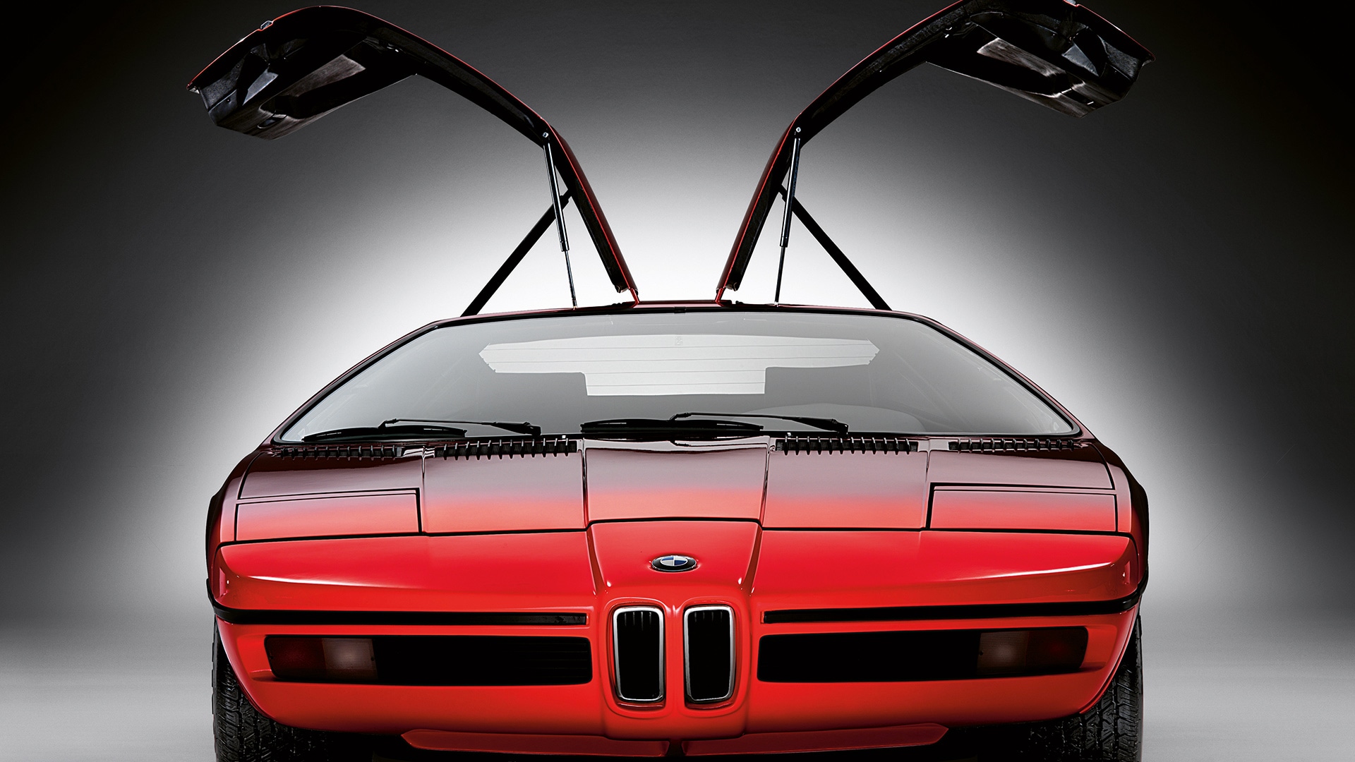 …la BMW Turbo orange-rouge de 1972. La porte en élytre de ce modèle légendaire rappelle celle du véhicule visionnaire.