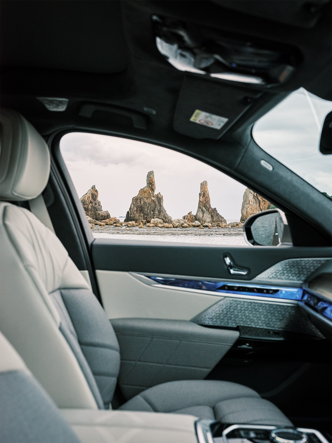 View from the interior of the BMW i7 onto the imposing Kushimoto coast rock formations.